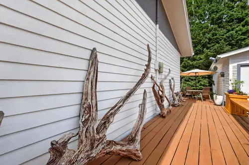 Beverly's driftwood pieces displayed along the deck rail