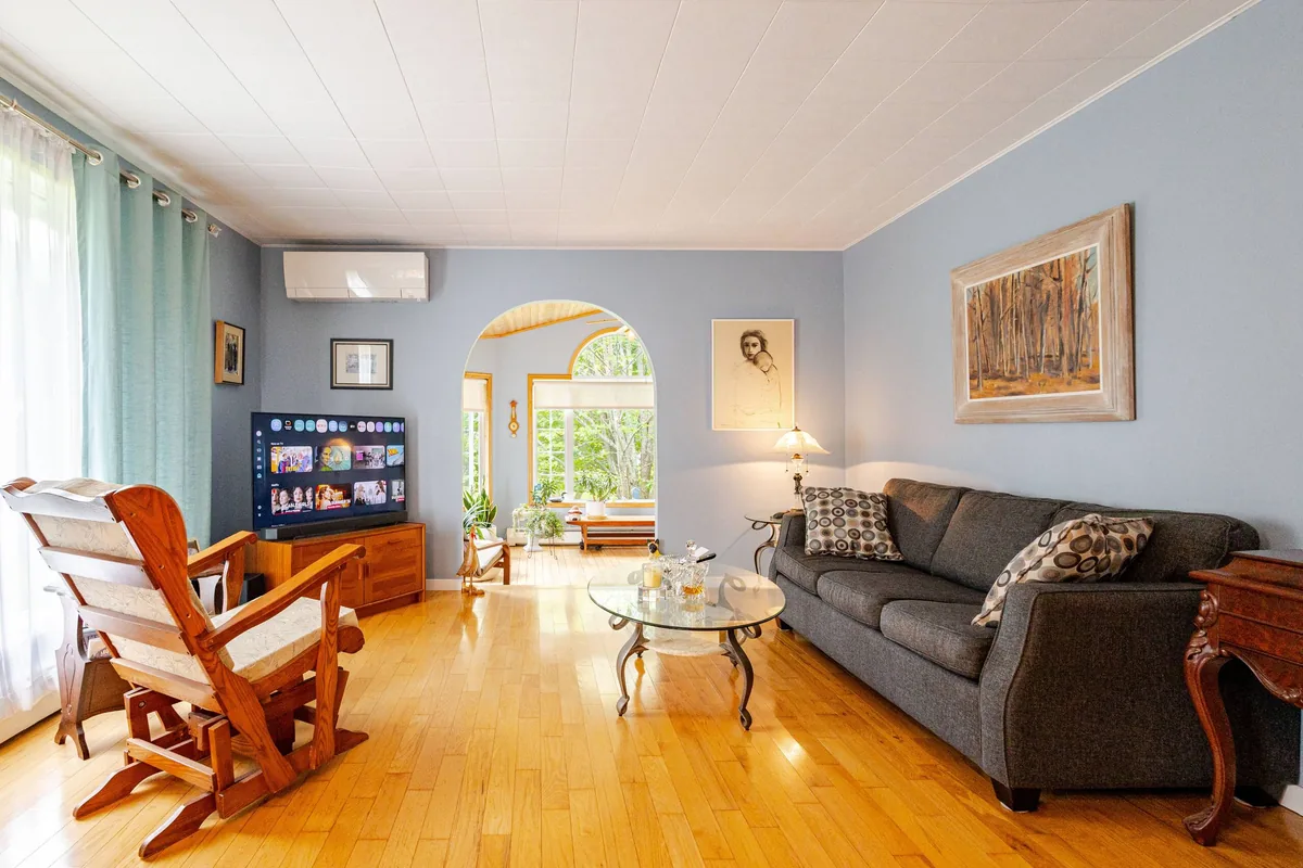 The shared living room, with the sunroom through the archway