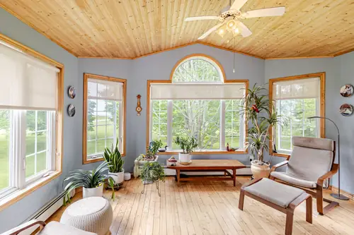 The sunroom, with windows on three sides